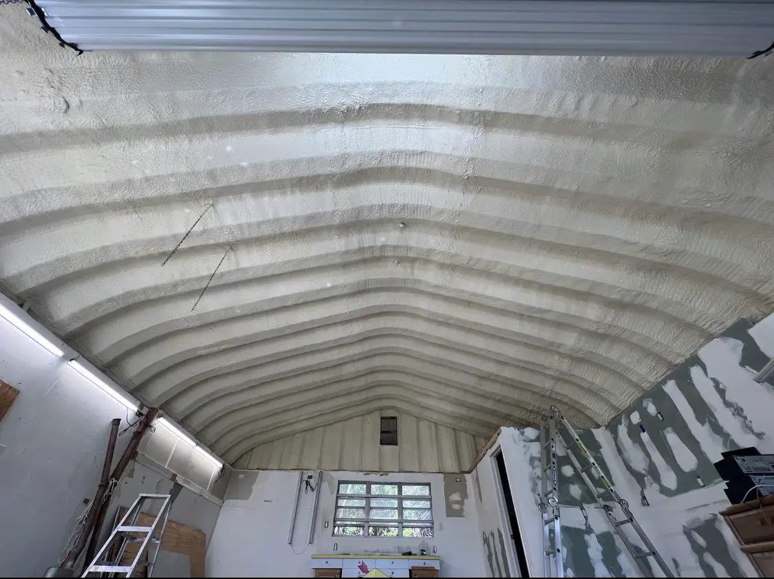 Spray polyurethane foam applied to the underside of a metal roof deck in Peculiar